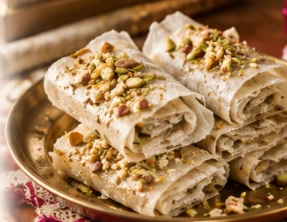 Delicate rice crepe sweets with almonds and pista